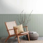 Interior_of_modern_living_room_with_wooden_armchair,_pouf_and_tree_branches