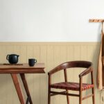 Stylish_scandinavian_dining_room_interior_with_mock_up_poster_frame,_wooden_table,_furniture,_teapot_with_cups,_black_decoration_and_elegant_accessories._Ready_to_use._Template._Modern_home_decor.